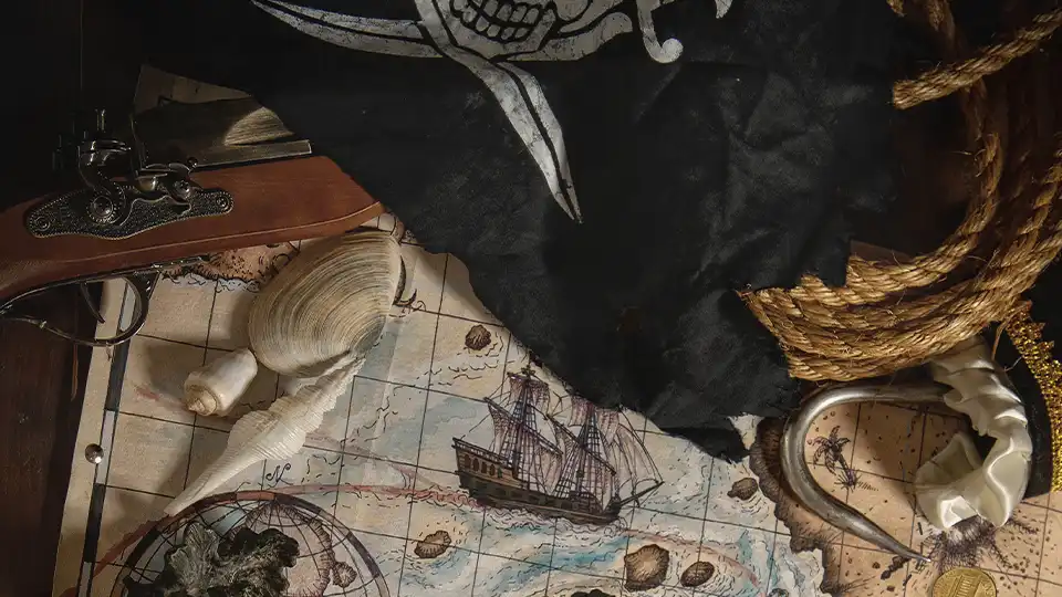 Eine Schatzkarte und Utensilien eines Piraten wie ein Haken, ein Seile und eine Pistole, Bild zum Quest "Piraten"